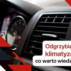 Widok na kratkę nawiewu klimatyzacji samochodowej i fragment deski rozdzielczej.