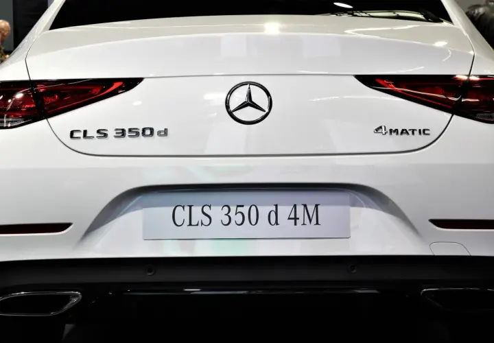 Tył białego Mercedesa CLS 350 d 4MATIC. Widoczne oznaczenia modeli i logo marki.